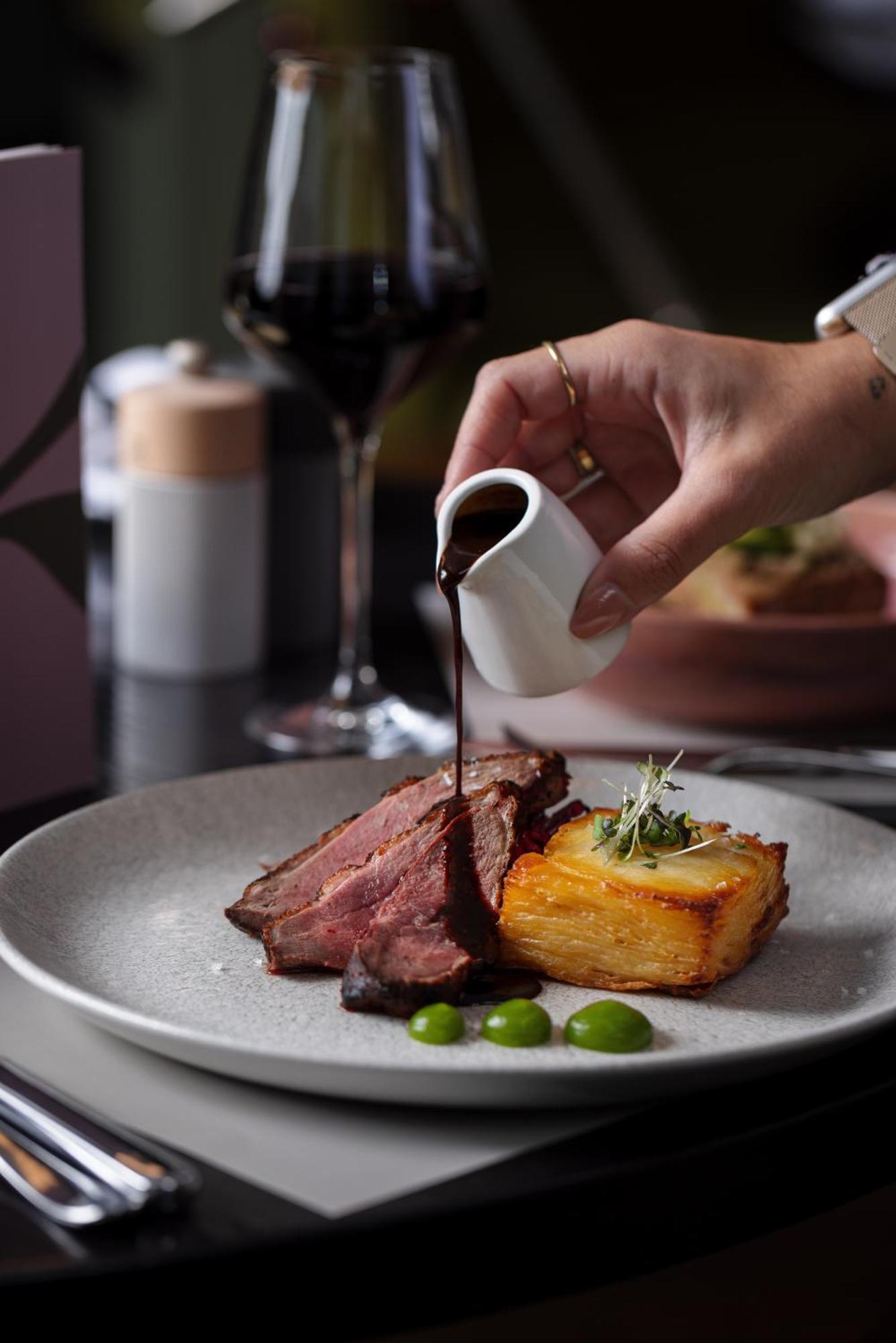 The Morrison Dublin, Curio Collection By Hilton Hotell Eksteriør bilde A steak being drizzled with a sauce